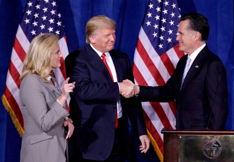 In this Thursday, Feb. 2, 2012 file photo, Donald Trump greets then Republican presidential candidate, Mitt Romney, after announcing his endorsement of Romney during a news conference in Las Vegas. Despite differences now, Romney said it is "likely" Trump will win reelection.