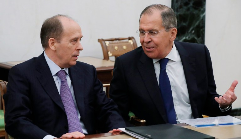 Russian Foreign Minister Sergey Lavrov speaks to Federal Security Service Director Alexander Bortnikov as they attend a security council meeting in the Kremlin in Moscow, Russia. Lavrov said Thursday that Moscow would "certainly" expel some British diplomats in a tit-for-tat response.