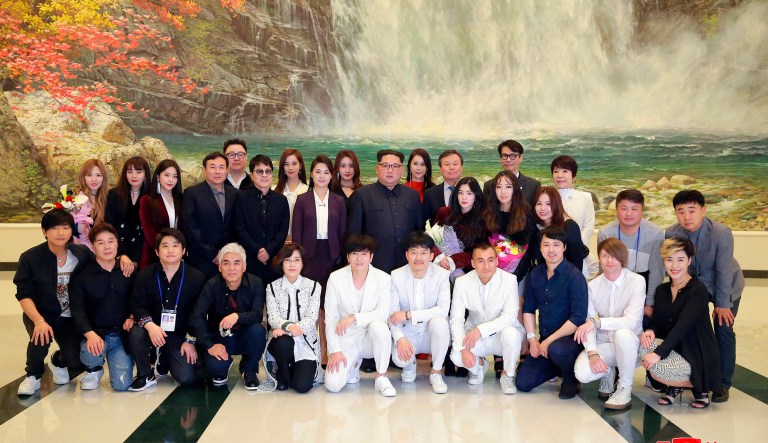 North Korean leader Kim Jong Un poses with his wife Ri Sol Ju, center left, and members of a South Korean artistic group after their performance in Pyongyang, North Korea.