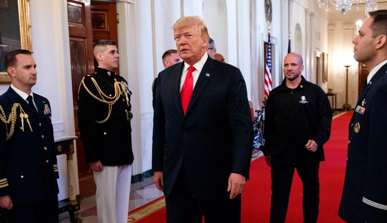 President Trump arrives to speak at an event in the East Room of the White House. 