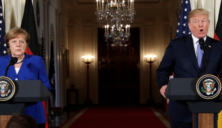 President Trump speaks during a news conference with German Chancellor Angela Merkel in the East Room of the White House. 