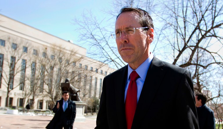 AT&T CEO Randall Stephenson leaves the federal courthouse, in Washington. 