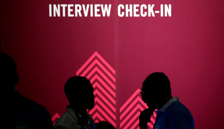 Job seekers chat during the Opportunity Fair and Forum employment event in Dallas. On Thursday, the Labor Department reports on the number of people who applied for unemployment benefits a week earlier. 