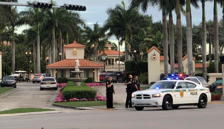 Police respond to The Trump National Doral resort after reports of a shooting inside the resort Friday in Doral, Fla.  A man shouting about Trump entered the president's south Florida golf course early Friday, draped a flag over a lobby counter and exchanged fire with police before being arrested, police said.