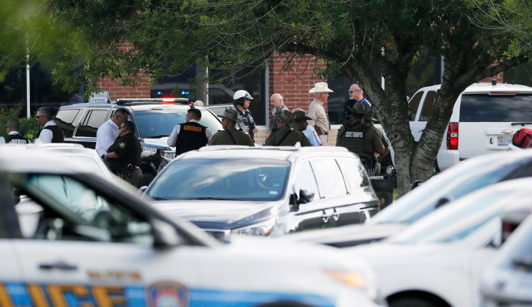 Emergency responders from multiple agencies work at the scene in front of Santa Fe High School in response to a shooting on Friday, in Santa Fe, Texas. 