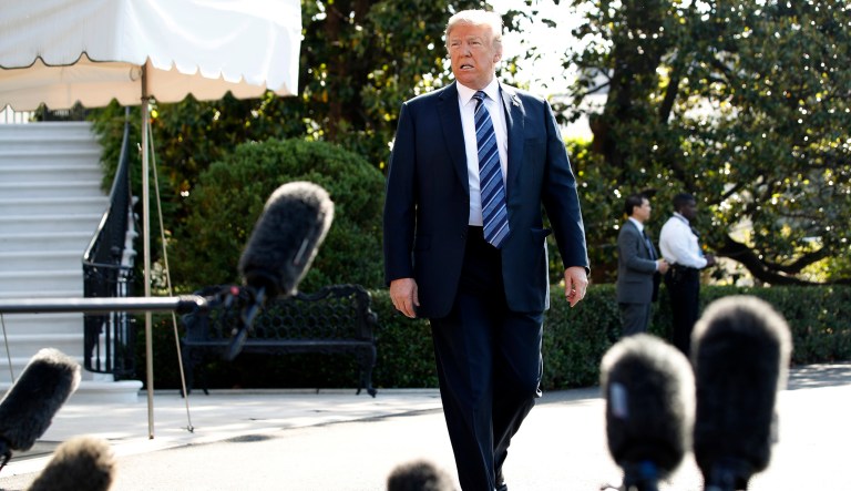 President Trump approaches the microphones to speak to the media as he walks to the Marine One helicopter on Friday on the South Lawn of the White House in Washington. Trump is traveling to Annapolis to address the U.S. Naval Academy.