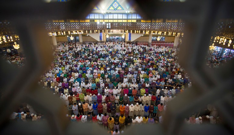 Muslims offer prayers during the first day of Eid al-Fitr, which marks the end of the holy fasting month of Ramadan. )