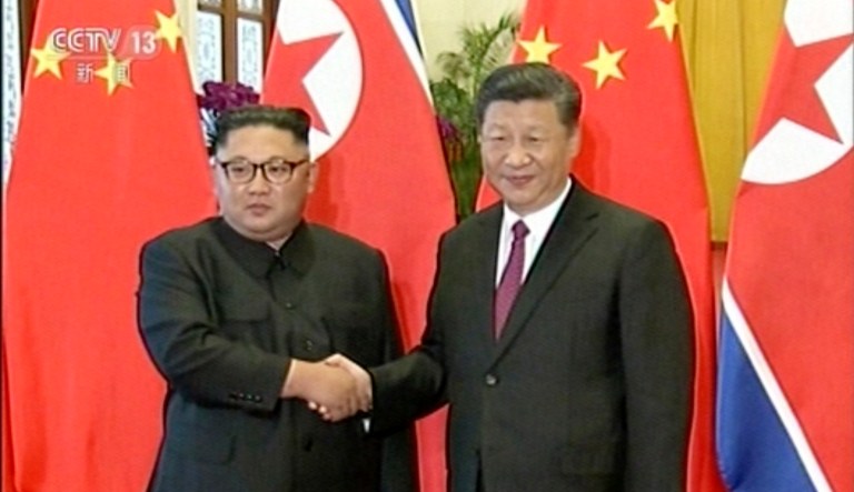 Chinese President Xi Jinping shakes hands with North Korean leader Kim Jong Un during a welcome ceremony at the Great Hall of the People in Beijing. 