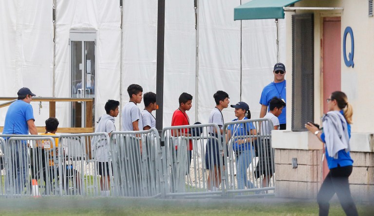 Immigrant children walk in a line outside the Homestead Temporary Shelter for Unaccompanied Children a former Job Corps site that now houses them in Homestead, Fla. 