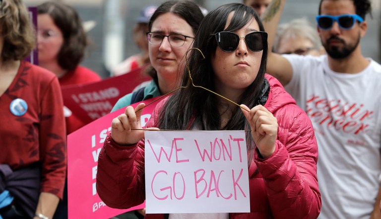 A protester takes part in a rally in Seattle against President Trump and his choice of federal appeals Judge Brett Kavanaugh as his second nominee to the Supreme Court.