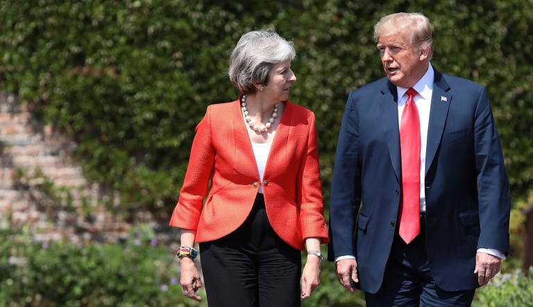 British Prime Minister Theresa May talks with President Trump prior to a joint press conference in England.