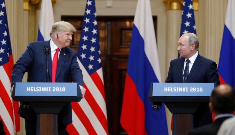President Trump looks to Russian President Vladimir Putin during a press conference after their meeting in Finland on July 16, 2018.