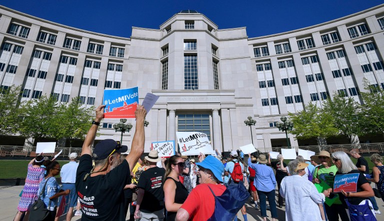 Demonstrators rally outside the Michigan Hall of Justice in Lansing, Mich., where the Michigan Supreme Court heard arguments about whether voters in November should be able to pass a constitutional amendment that would change how the stateâs voting maps are drawn or whether such changes could only be adopted at a rarely held constitutional convention. 