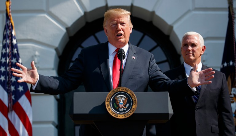 Vice President Mike Pence looks on as President Trump delivers remarks about the economy on the South Lawn of the White House. 