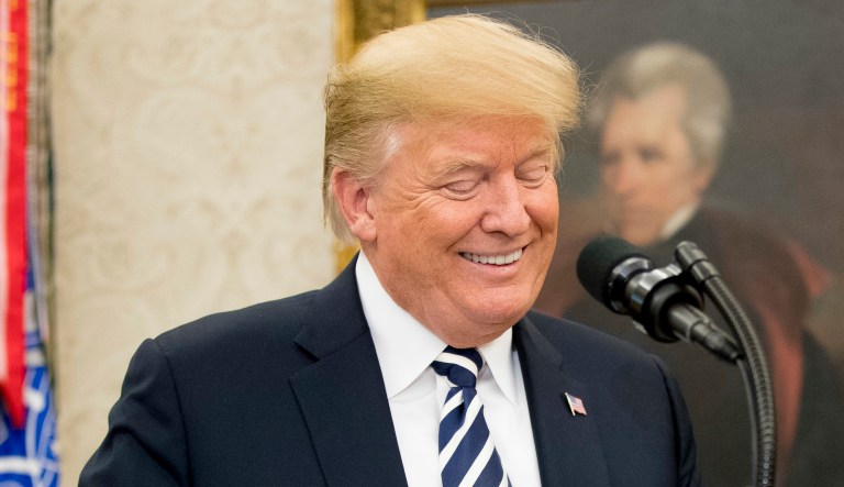 President Trump jokes during a ceremony in the Oval Office of the White House on July 30, 2018, in Washington.