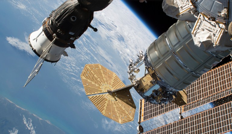 NASA and Russian space officials stressed Thursday, Aug. 30, 2018, that the six astronauts are in no danger after a small air leak developed in one, at left, of the two Soyuz capsules docked at the space station. 
