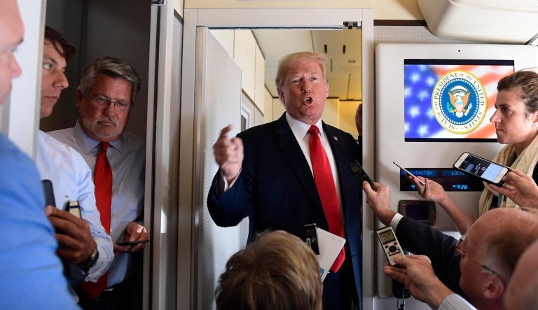 President Trump talks to reporters while in flight from Billings, Mont., to Fargo, N.D., Friday. 