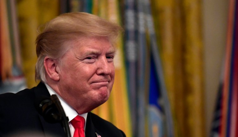 President Trump speaks during a reception in the East Room of the White House.