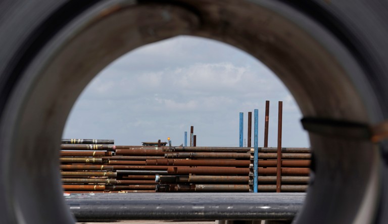In this June 5, 2018, file photo, steel pipes are seen through a roll of steel at the Borusan Mannesmann Pipe manufacturing facility in Baytown, Texas.