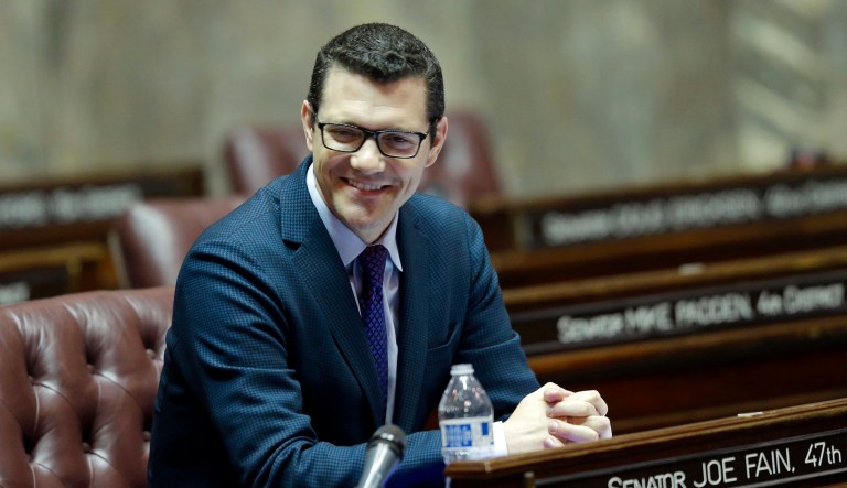 State Senate Republican floor leader Joe Fain, R-Auburn, sits at his desk on the Senate floor in Olympia, Wash.