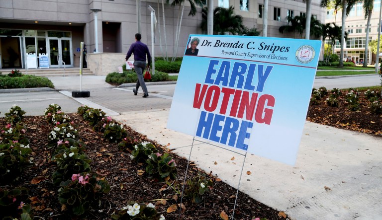 A sign is displayed on the first day of early voting, Monday, Oct. 22, 2018, at Nova Southeastern University in Davie, Fla.