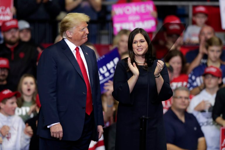 President Donald Trump and press secretary Sarah Huckabee Sanders listen to a speech at a campaign rally at the Allen County War Memorial Coliseum in Fort Wayne, Indiana, Monday, Nov. 5, 2018.
