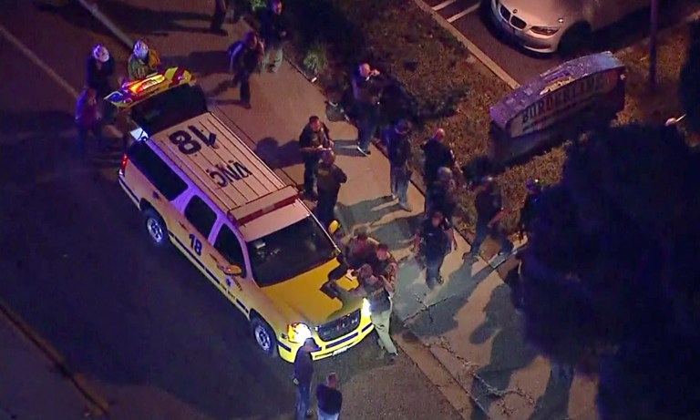 This image made from aerial video show officers around a police SUV in the vicinity of a shooting in Thousand Oaks, Calif., early Thursday.