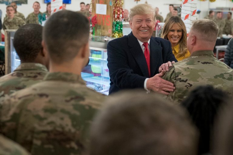 President Donald Trump and first lady Melania Trump visit with members of the military at a dining hall at Al Asad Air Base, Iraq, Wednesday, Dec. 26, 2018. In a surprise trip to Iraq, President Donald Trump on Wednesday defended his decision to withdraw U.S. forces from Syria where they have been helping battle Islamic State militants.