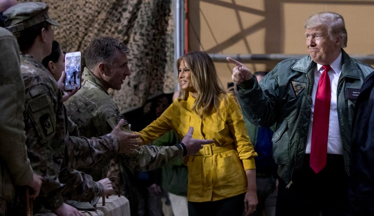 President Trump and first lady Melania Trump greet members of the military as they arrive for a hangar rally at Al Asad Air Base, Iraq, Wednesday, Dec. 26, 2018. In a surprise trip to Iraq, President Trump on Wednesday defended his decision to withdraw U.S. forces from Syria where they have been helping battle Islamic State militants.