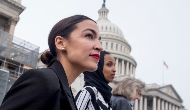 Rep. Alexandria Ocasio-Cortez, D-N.Y., left, and Rep. Ilhan Omar, D-Minn., center, walk down the House steps to take a group photograph of the House Democratic women members of the 116th Congress on the East Front Capitol Plaza on Capitol Hill in Washington, Friday, Jan. 4, 2019, as the 116th Congress begins. Also pictured is Rep. Dina Titus, D-Nev., right.