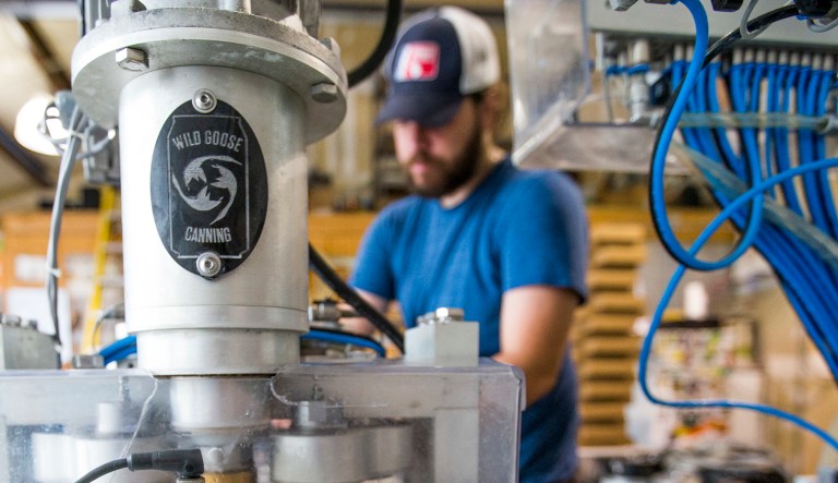 In this Aug. 12, 2016, photo Bare Hands Brewery cans it's Reasoning Session IPA at Bare Hands Brewery in Granger, Ind. Breweries, wineries, and distilleries in Indiana and Michigan are experiencing delays because some permits are not being issued due to the partial federal government shutdown.