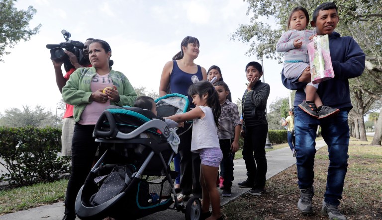 Immigrant children and their families wait in line to receive free toys outside of an U.S. Immigration and Customs Enforcement facility, Wednesday, Jan. 9, 2019, in Miramar, Fla. Various groups supporting immigrant rights represent the Circle of Protection, which hosted a Three Kings Day celebration and a toy giveaway for the children of immigrant families checking in at the ICE facility.