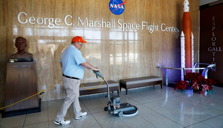 A worker cleans the floors at NASA's Marshall Space Flight Center, which has been impacted by the partial federal government shutdown at the Army's Redstone Arsenal in Huntsville, Ala., Wednesday, Jan. 9, 2019.