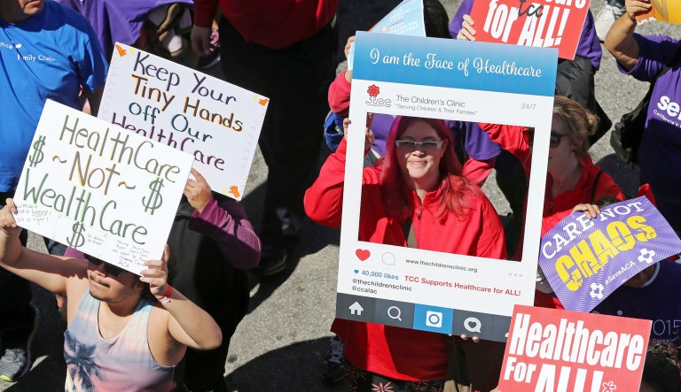 In this March 23, 2017, file photo, hundreds of people march through downtown Los Angeles protesting President Trump's plan to dismantle the Affordable Care Act, his predecessor's signature health care law. 