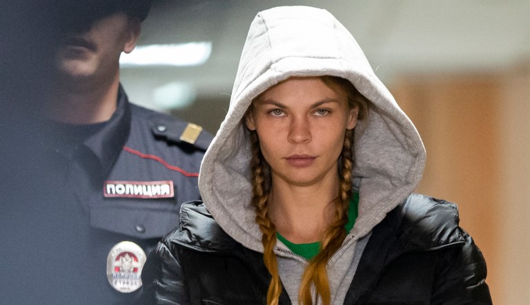 Anastasia Vashukevich, also known on social media as Nastya Rybka, is escorted in the court room in Moscow, Russia, Saturday, Jan. 19, 2019. A Belarusian model who claimed last year that she had evidence of Russian interference in the election of Donald Trump as U.S. president was arrested immediately upon her arrival in Moscow on Thursday following deportation from Thailand.