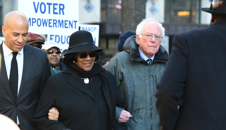 Following a Martin Luther King Jr. prayer service at Zion Baptist Church in Columbia, S.C., on Monday, Jan. 21, 2019, New Jersey Sen. Cory Booker, D-N.J., left, and Sen. Bernie Sanders, I-Vt., right walk with NAACP President Brenda Murphy during a march to the Statehouse. 