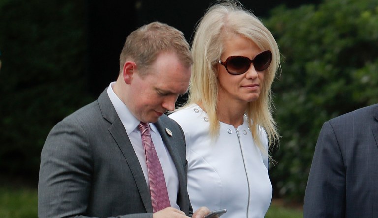 Cliff Sims, left, director of White House message strategy, stands with Kellyanne Conway, center, senior adviser to President Trump, as they listen to Trump welcome the 2016 NCAA Football National Champions Clemson University Tigers, Monday, June 12, 2017, during a ceremony on the South Lawn of the White House in Washington.