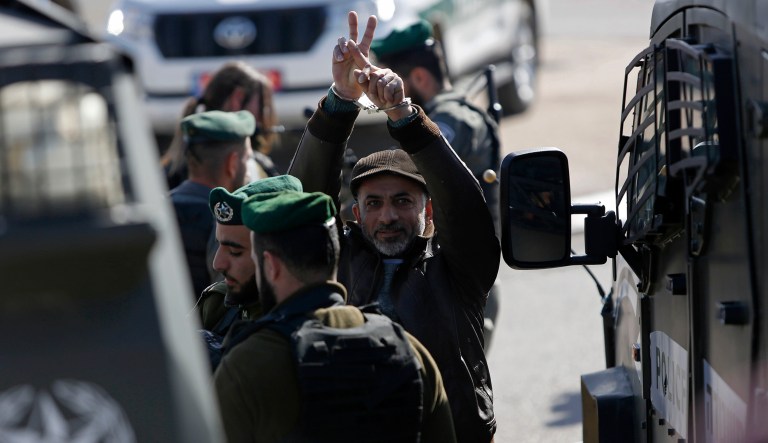 Israeli forces detain a Palestinian protester during a demonstration against a newly opened Israeli highway that has a concrete wall segregating Israeli and Palestinian traffic, near Jerusalem, Wednesday, Jan. 23, 2019.