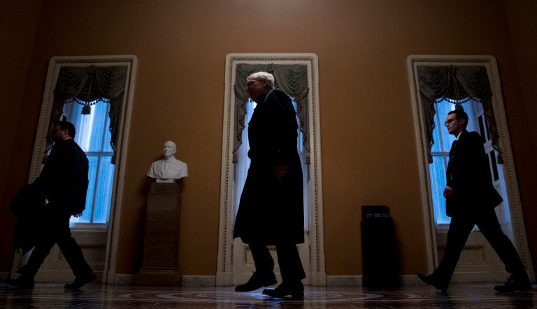 Senate Majority Leader Mitch McConnell, center, of Ky. arrives on Capitol Hill in Washington, Thursday, Jan. 24, 2019.