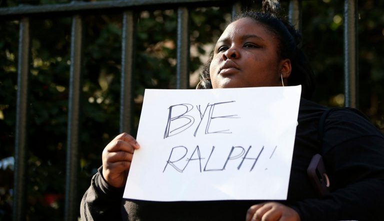 Zyahna Bryant of Charlottesville holds a sign at a protest calling for Governor Ralph Northam to resign on Monday Feb. 4, 2019 after photos surfaced from Northam's 1984 Eastern Virginia Medical School yearbook depicting one person in blackface and another in a Ku Klux Klan outfit.
