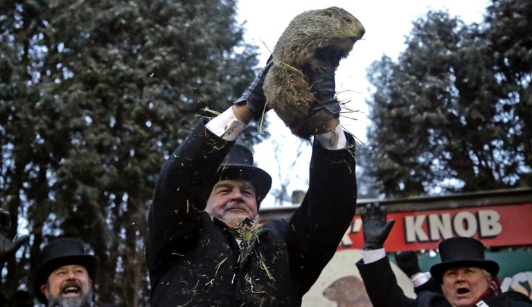 Groundhog Club co-handler John Griffiths, center, holds Punxsutawney Phil, the weather prognosticating groundhog, during the 133rd celebration of Groundhog Day on Gobbler's Knob in Punxsutawney, Pa. Saturday, Feb. 2, 2019.  Phil's handlers said that the groundhog has forecast an early spring.     