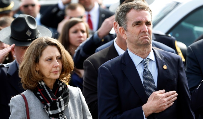 Virginia Gov. Ralph Northam, right, and his wife Pam, watch as the casket of fallen Virginia State Trooper Lucas B. Dowell is carried to a waiting tactical vehicle during the funeral at the Chilhowie Christian Church in Chilhowie, Va., Saturday, Feb. 9, 2019. Dowell was killed  in the line of duty earlier in the week. 