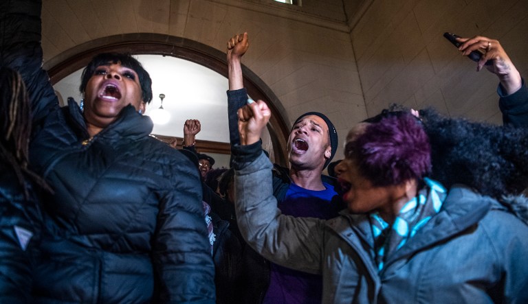 People, including Khalil Darden, 18, of Penn Hills, Pa., center, and Pennsylvania State Rep. Summer Lee, right, protest after they learned a not guilty verdict in the homicide trial of former East Pittsburgh police Officer Michael Rosfeld, in Pittsburgh, Pa.