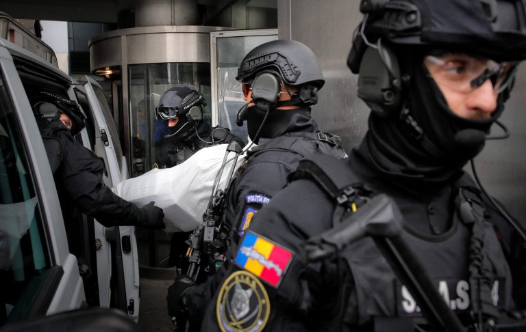 Romanian special police troops carry bags of cocaine outside the building of the Directorate for Investigating Organized Crime and Terrorism in Bucharest, Romania, Tuesday, March 26, 2019. The DIICOT arrested the Tate brothers on Thursday, Dec. 29, 2022. (AP Photo/Vadim Ghirda)