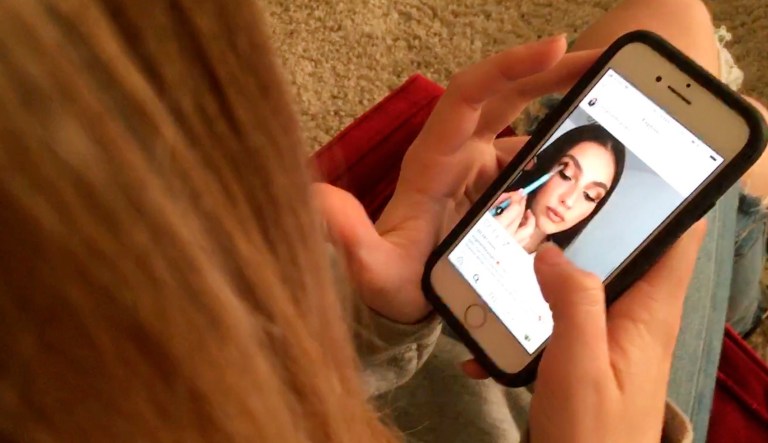 In this Nov. 1, 2018, file photo, a teenager looks at Instagram on a smartphone in San Francisco.