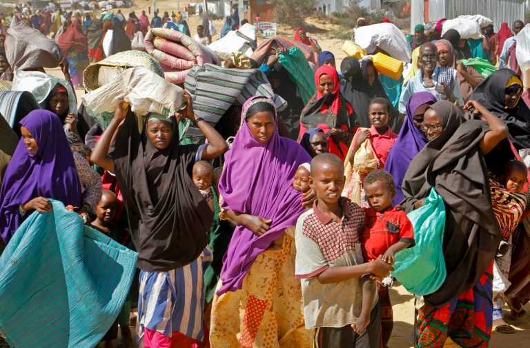 People fleeing from drought in the Lower and Middle Shabelle regions of Somalia carry their belongings as they reach a makeshift camp for displaced persons in the Daynile neighborhood on the outskirts of the capital Mogadishu. 