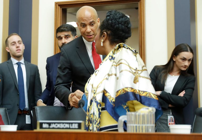 Sen. Cory Booker, D-N.J., center, shakes hands with Rep. Sheila Jackson Lee, D-Texas, after testify about reparation for the descendants of slaves during a hearing before the House Judiciary Subcommittee on the Constitution, Civil Rights and Civil Liberties, at the Capitol in Washington, Wednesday, June 19, 2019.