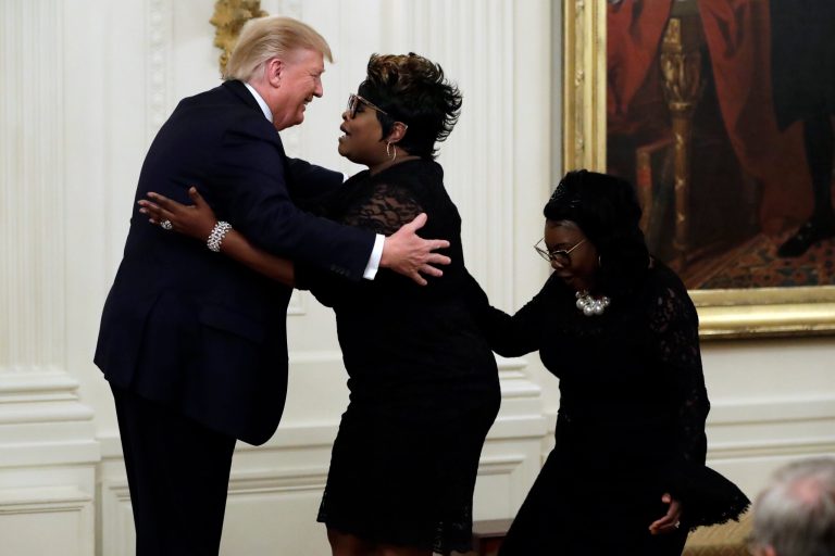President Donald Trump hugs Diamond and Silk during the Presidential Social Media Summit in the East Room.