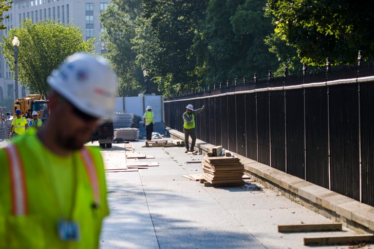 Construction crews work on renovations to the perimeter fence on the North Lawn of the White House, Friday, July 19, 2019, in Washington. The Secret Service says the $64 million construction project will be for a 13-foot, 1-inch (3.96-meter) fence with wider and stronger pickets.
