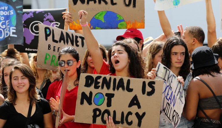 Students cheer during a protest organized by the U.S. Youth Climate Strike outside of Miami Beach City Hall, as part of a global day of climate action, Friday, Sept. 20, 2019, in Miami Beach, Fla.